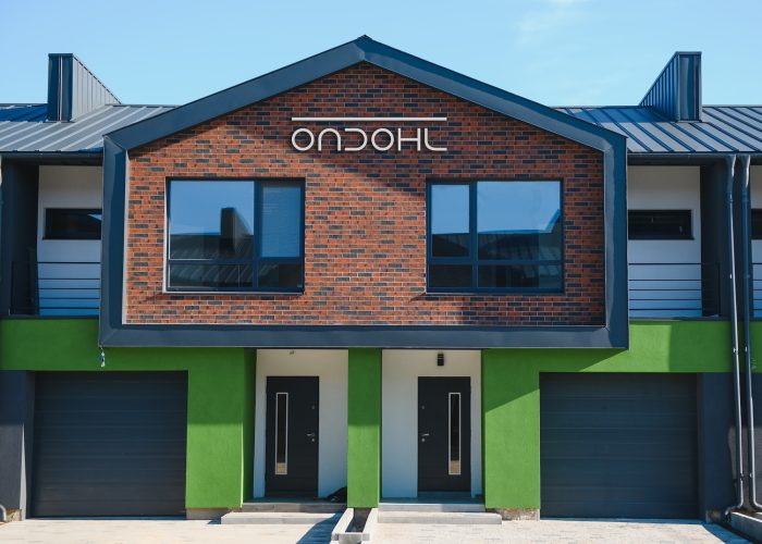 A row of residential townhomes or townhouses in suburb. Concept of real estate development, the housing market, and homeownership.