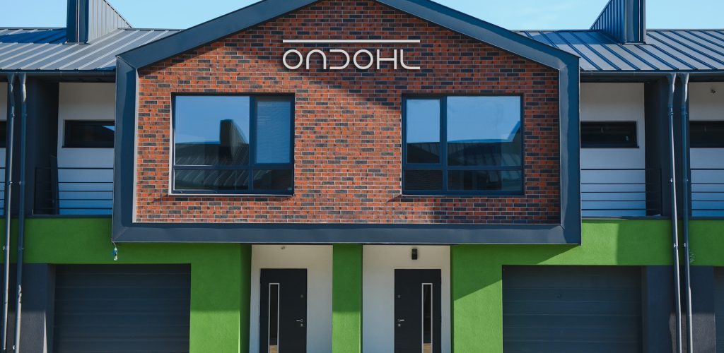 A row of residential townhomes or townhouses in suburb. Concept of real estate development, the housing market, and homeownership.